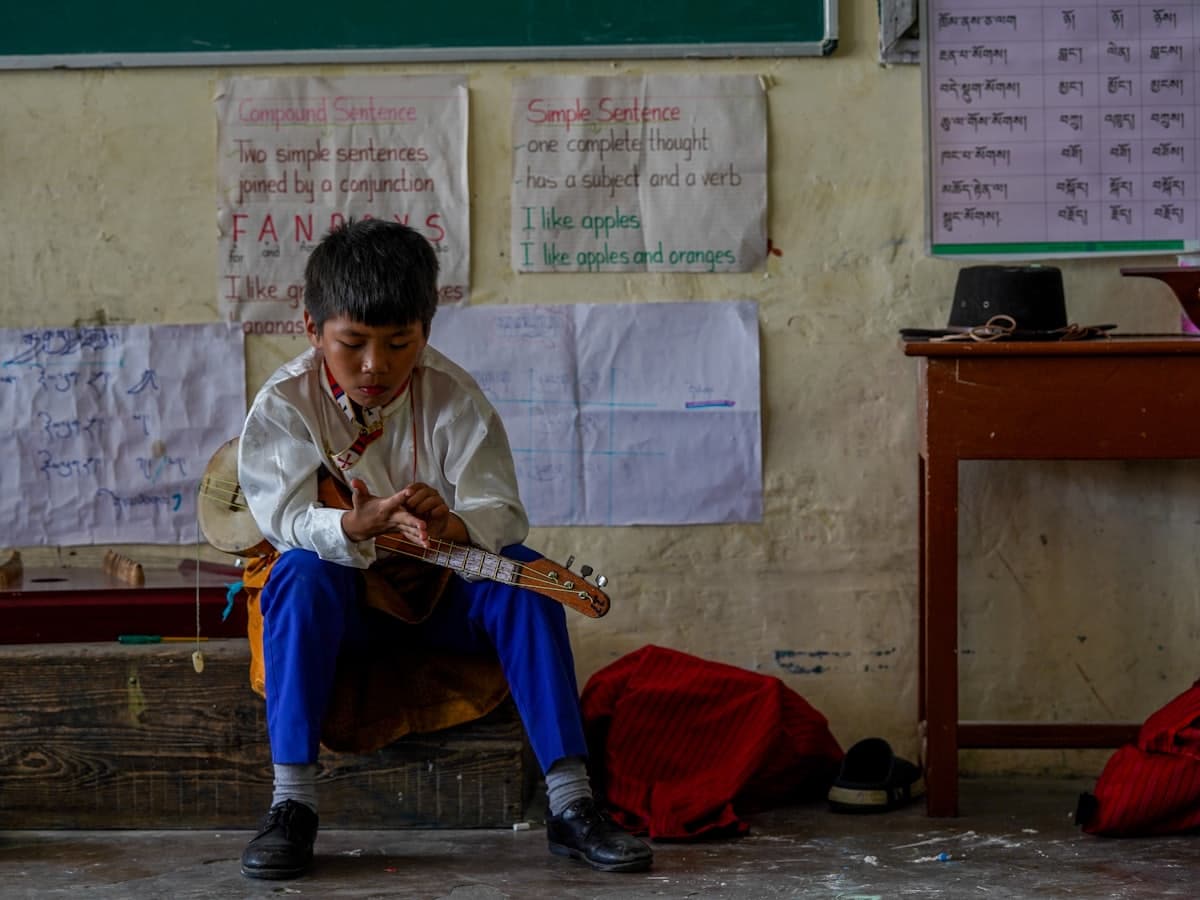 A child learning a musical instrument in an activity class